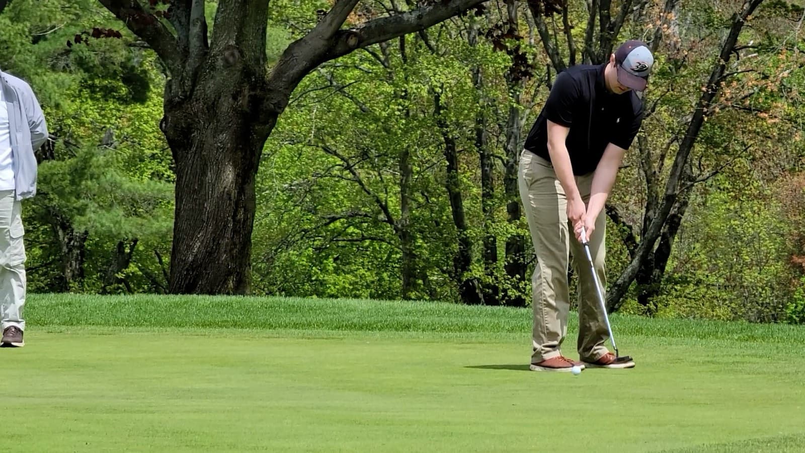 A golfer lines up a putt at the foundation's annual golf outing fundraiser